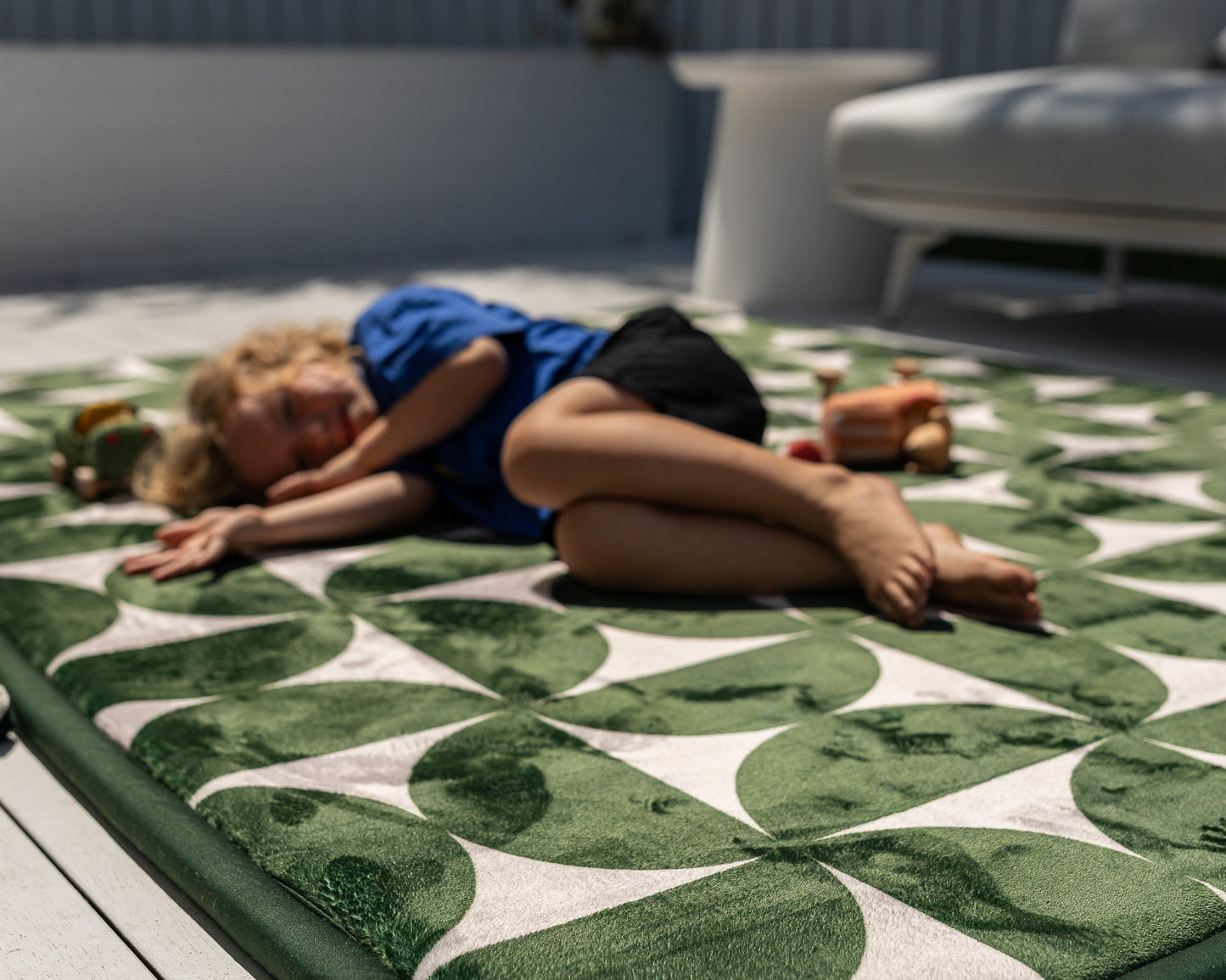 Modern mid-century baby floor mat – green and beige retro pattern styled in neutral home interior