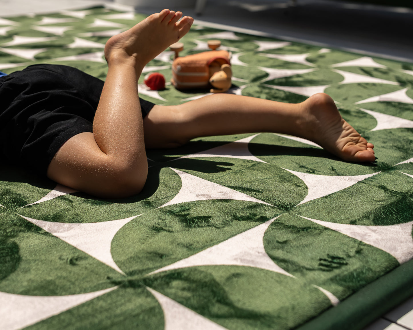 The Retro Arc Play Mat by Little Mat Co – non-toxic foam baby play mat in dark green and beige