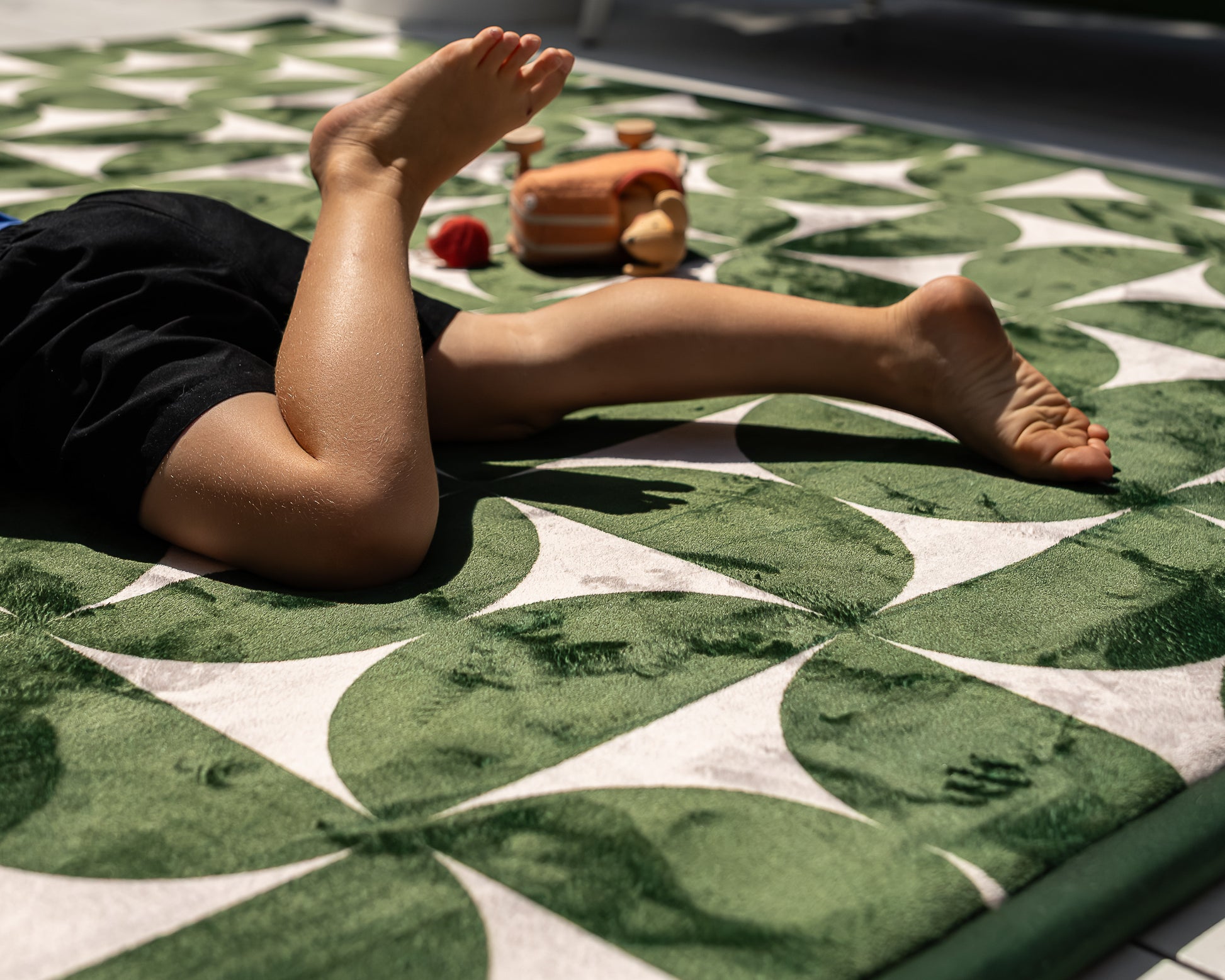 The Retro Arc Play Mat by Little Mat Co – non-toxic foam baby play mat in dark green and beige