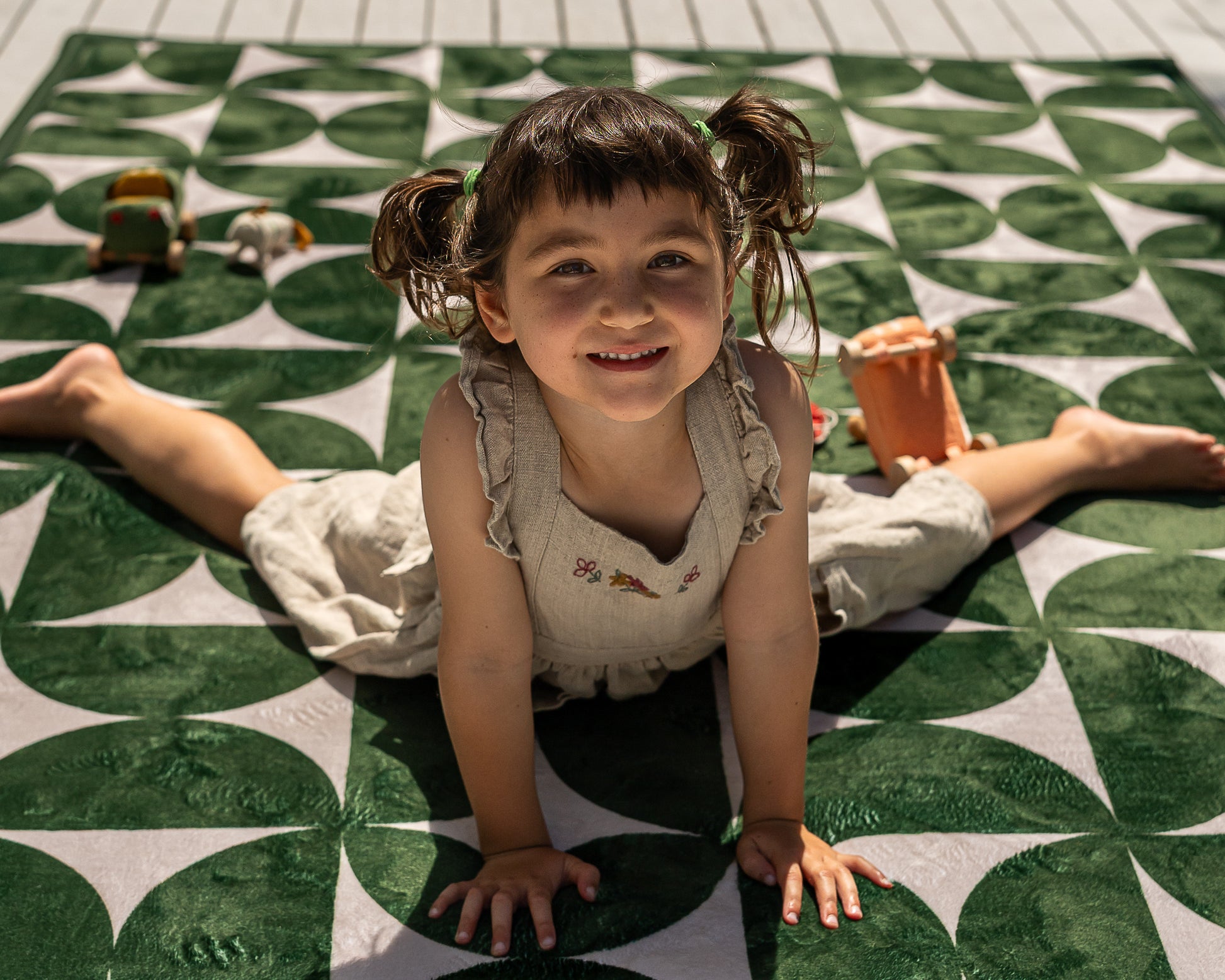 Non-toxic foam baby play mat in modern mid-century design – dark green and neutral tones in family living room