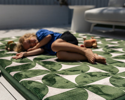 Modern mid-century baby floor mat – green and beige retro pattern styled in neutral home interior