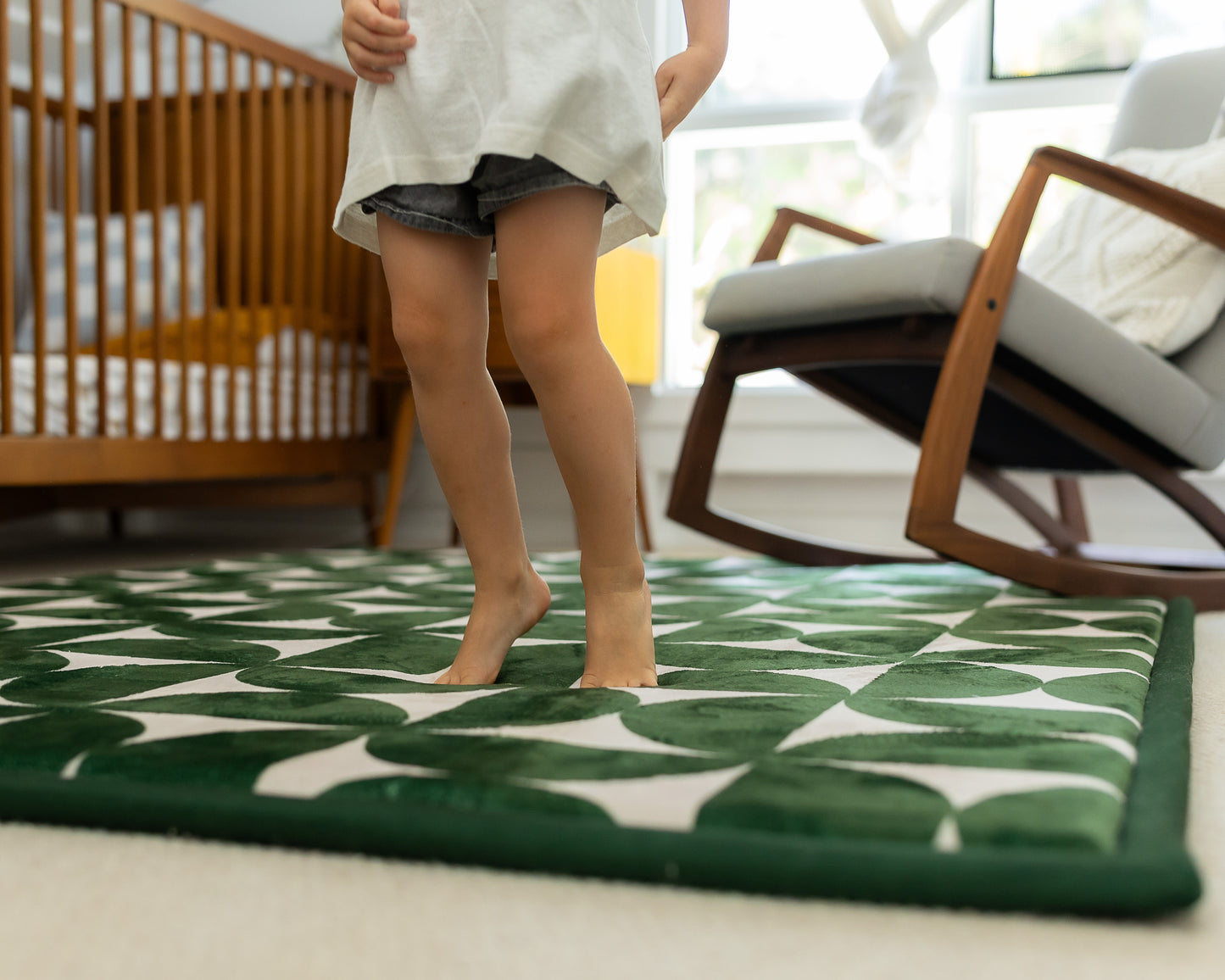 Non-toxic foam baby play mat in modern mid-century design – dark green and neutral tones in family living room